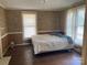 This bedroom features two windows for natural light, wooden floors, and unique wall textures at 8350 Nc Hwy 90 E Hwy, Stony Point, NC 28678