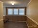 This bedroom features classic wood paneling, three windows for natural light, and a built-in bench at 8350 Nc Hwy 90 E Hwy, Stony Point, NC 28678