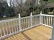 View of a newly constructed wooden deck with white railings and a view of the surrounding landscape at 8350 Nc Hwy 90 E Hwy, Stony Point, NC 28678