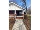 Charming brick home featuring a covered front porch with classic columns and inviting curb appeal at 8350 Nc Hwy 90 E Hwy, Stony Point, NC 28678