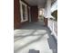 Comfortable covered front porch with painted wood floor and brick pillars, perfect for outdoor relaxing at 8350 Nc Hwy 90 E Hwy, Stony Point, NC 28678