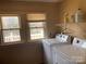 Well-lit laundry room with washer, dryer, shelving, and two windows for natural light and ventilation at 8350 Nc Hwy 90 E Hwy, Stony Point, NC 28678