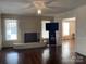 Spacious living room featuring hardwood floors, a fireplace and large windows at 8350 Nc Hwy 90 E Hwy, Stony Point, NC 28678