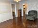 This charming living room with hardwood floors features a comfortable chair and a view to other rooms at 8350 Nc Hwy 90 E Hwy, Stony Point, NC 28678