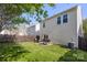Well-maintained backyard featuring green grass, a fence, a patio with grill, and outdoor dining set at 8917 Chalkstone Rd, Charlotte, NC 28216