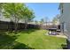 Spacious backyard with lush lawn, trees, privacy fence, and patio area great for outdoor enjoyment at 8917 Chalkstone Rd, Charlotte, NC 28216