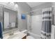 Well-lit bathroom featuring a shower-tub combo, a stylish mirror and neutral paint at 8917 Chalkstone Rd, Charlotte, NC 28216
