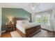 Cozy bedroom featuring a large bed, hardwood floors, and natural light from the window at 8917 Chalkstone Rd, Charlotte, NC 28216