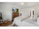 Bright bedroom with a dresser and television, hardwood floors and neutral walls at 8917 Chalkstone Rd, Charlotte, NC 28216