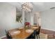 Inviting dining room features a modern light fixture and a view into the adjacent rooms at 8917 Chalkstone Rd, Charlotte, NC 28216
