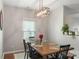 Dining room with wooden table, black chairs, and unique, modern chandelier at 8917 Chalkstone Rd, Charlotte, NC 28216