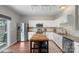 Modern kitchen with white cabinets, butcher block island, stainless steel appliances, and outdoor access at 8917 Chalkstone Rd, Charlotte, NC 28216