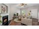 Bright living room featuring a fireplace, hardwood floors, and comfortable sofas at 8917 Chalkstone Rd, Charlotte, NC 28216
