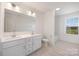 Bright bathroom featuring a double vanity, light wood-look flooring and a separate bath tub at 9913 Jack Nicklaus Dr # 908, Lancaster, SC 29720