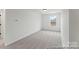 Bright, carpeted room with a window providing natural light and a clean, minimalist aesthetic at 9913 Jack Nicklaus Dr # 908, Lancaster, SC 29720
