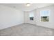 Bright, empty bedroom with two windows offering natural light and views of the surroundings at 9913 Jack Nicklaus Dr # 908, Lancaster, SC 29720