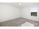 Bright, empty bedroom with a window providing natural light and a cozy carpet at 9913 Jack Nicklaus Dr # 908, Lancaster, SC 29720