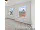 Carpeted room featuring two windows providing ample natural light and views of the outdoors at 9913 Jack Nicklaus Dr # 908, Lancaster, SC 29720