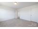 Carpeted empty bedroom with a window and doorway, awaiting your personal touch at 9913 Jack Nicklaus Dr # 908, Lancaster, SC 29720