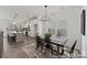 Open-concept dining area with stylish light fixture and hardwood flooring at 9913 Jack Nicklaus Dr # 908, Lancaster, SC 29720