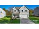 Charming two-story home featuring a manicured lawn and a classic gray facade at 9913 Jack Nicklaus Dr # 908, Lancaster, SC 29720