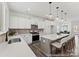 Modern kitchen with stainless steel appliances, white cabinets, and a large central island at 9913 Jack Nicklaus Dr # 908, Lancaster, SC 29720