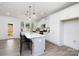 Bright kitchen with white cabinets, quartz countertops, and a large center island with bar stool seating at 9913 Jack Nicklaus Dr # 908, Lancaster, SC 29720