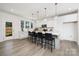 Bright kitchen with white cabinets, quartz countertops, and a large center island with bar stool seating at 9913 Jack Nicklaus Dr # 908, Lancaster, SC 29720