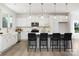 Bright kitchen with white cabinets, quartz countertops, and a large center island with bar stool seating at 9913 Jack Nicklaus Dr # 908, Lancaster, SC 29720