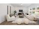 Bright living room with a large window, modern furniture, and a mounted television at 9913 Jack Nicklaus Dr # 908, Lancaster, SC 29720