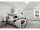 Tranquil main bedroom featuring tray ceilings, neutral colors, and large windows with natural light at 9913 Jack Nicklaus Dr # 908, Lancaster, SC 29720