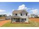 Rear exterior view of the two-story home with a screened porch and landscaped yard at 9913 Jack Nicklaus Dr # 908, Lancaster, SC 29720