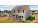 Exterior shot of a two-story home featuring a screened-in porch, landscaping, and well-maintained lawn at 9913 Jack Nicklaus Dr # 908, Lancaster, SC 29720