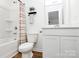 This bathroom features a bath tub and shower combo, a vanity sink, and laminate flooring at 10031 Travis Floyd Ln, Charlotte, NC 28214