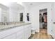 This bathroom features a white double vanity, granite counters, and a separate closet for linens and clothes at 10031 Travis Floyd Ln, Charlotte, NC 28214