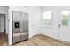 Bright kitchen with stainless steel refrigerator and access to an exterior door at 10031 Travis Floyd Ln, Charlotte, NC 28214