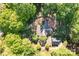 Aerial view of the wooded property with both structures on the lot at 101 Blueberry Hill Dr, Statesville, NC 28625