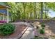 Backyard with a brick patio, walkway, and lush greenery at 101 Blueberry Hill Dr, Statesville, NC 28625