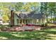 A charming home with a brick chimney, surrounded by lush trees and landscaping at 101 Blueberry Hill Dr, Statesville, NC 28625