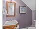 Bathroom with wood-framed mirror, white sink, and painted in a unique color at 101 Blueberry Hill Dr, Statesville, NC 28625