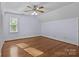 A spacious bedroom features hardwood floors and a ceiling fan with light fixture at 101 Blueberry Hill Dr, Statesville, NC 28625