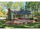 A charming home with a brick chimney, surrounded by lush trees and landscaping at 101 Blueberry Hill Dr, Statesville, NC 28625