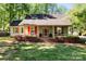 Inviting home showcasing colorful flowers and a cozy front porch with vibrant shutters at 101 Blueberry Hill Dr, Statesville, NC 28625