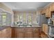 Kitchen island featuring granite counters, a stainless sink, and wooden cabinetry at 101 Blueberry Hill Dr, Statesville, NC 28625