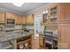 Open kitchen with granite counters, wood cabinets, a built-in desk area, and hardwood floors at 101 Blueberry Hill Dr, Statesville, NC 28625