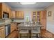 Bright kitchen boasts wooden cabinets, stainless steel appliances, and a granite island with seating at 101 Blueberry Hill Dr, Statesville, NC 28625