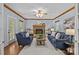 Cozy living room featuring a brick fireplace, bookshelves and comfortable seating at 101 Blueberry Hill Dr, Statesville, NC 28625
