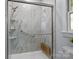 Accessible shower with glass doors, safety grab bars, and built-in shelving at 101 Blueberry Hill Dr, Statesville, NC 28625
