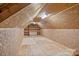 Unfinished attic with shelves, lighting, and plywood walls at 101 Blueberry Hill Dr, Statesville, NC 28625