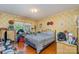 Bedroom with floral wallpaper, hardwood floors, and a comfortable bed, creating a cozy and inviting space at 102 Forest Ct, Huntersville, NC 28078